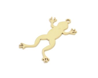 May include: A gold-colored metal frog charm with a simple silhouette design.