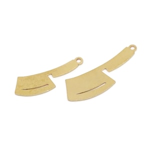 May include: Two gold-colored metal cleaver charms. The charms have a curved blade with a horizontal slit and a handle with a small hole for attaching to jewelry. The cleavers are different sizes.
