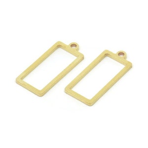 May include: Two gold-colored metal rectangular frame pendants with a small loop at the top.
