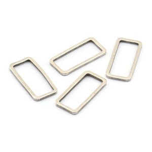 May include: Four silver metal rectangular rings, ideal for attaching to jewellery or crafts.