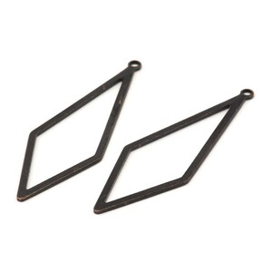 May include: Two black diamond-shaped metal earring blanks with a hole at the top.