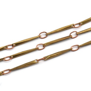 May include: A gold chain with long, pointed links connected by small, round copper links.