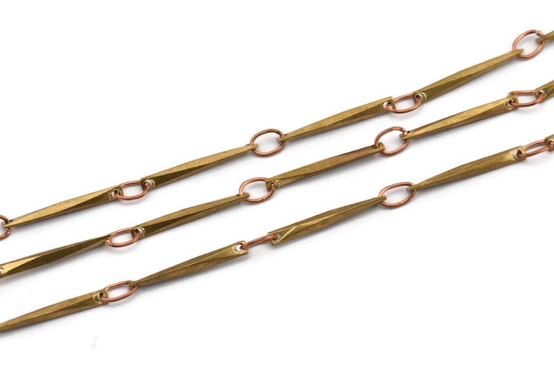 May include: A gold chain with long, pointed links connected by small, round copper links.