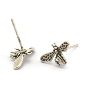 May include: A pair of silver bee stud earrings. Each earring features a detailed bee design with intricate wings.