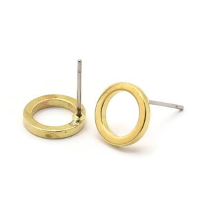 May include: A pair of gold-toned circle stud earrings with a simple design. The earrings have a post and butterfly backing.