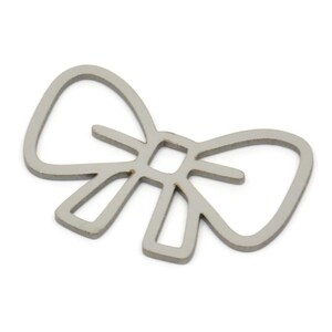May include: A silver metal bow tie charm with a simple outline design.
