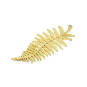 May include: A gold-colored metal fern leaf charm with a hole at the top for hanging.