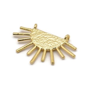 May include: Gold-toned metal pendant with a textured half-circle shape and radiating spikes.