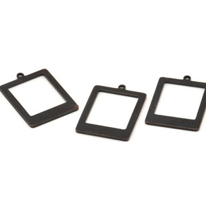 May include: Three black metal picture frame charms with a rounded top and a hole for hanging. The frames are empty and ready to be personalised.