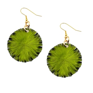 May include: A pair of green circular earrings with a textured, radial design. The earrings have gold hooks and a gold chain connecting the hook to the earring.