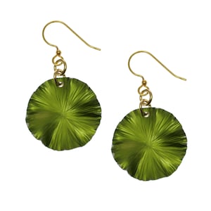 May include: A pair of green, round earrings with a textured, sunburst design. The earrings are made of metal and have gold-toned hooks.