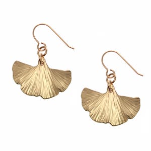 May include: A pair of gold-tone ginkgo leaf dangle earrings with a delicate wire hook.