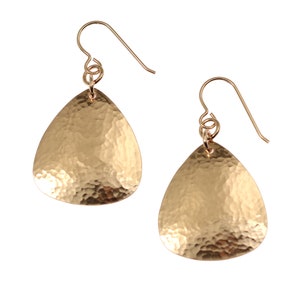 May include: A pair of gold hammered teardrop earrings with a simple wire hook closure.