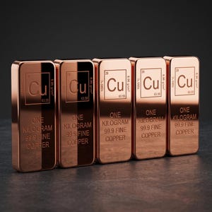 May include: Five rectangular copper bars, each weighing one kilogram and marked 99.9 fine copper. Each bar features the periodic table symbol Cu, atomic number 29, atomic mass 63.55, density 8.96 g/cm3, and melting point 1085 degrees Celsius.