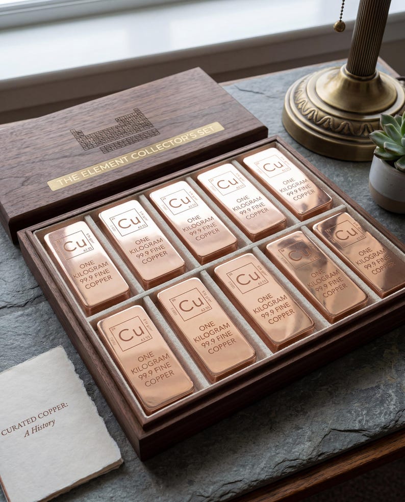 May include: A wooden box set labeled "THE ELEMENT COLLECTOR'S SET" contains ten copper bars. Each bar is stamped with "Cu", "ONE KILOGRAM 99.9 FINE COPPER". The set includes a small booklet titled "CURATED COPPER: A History".