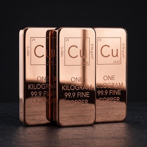May include: Three rectangular copper bars with a polished metallic finish. Each bar features the periodic table symbol Cu, atomic number 29, melting point 1085°C, density 8.96 g/cm3, atomic mass 63.55, and the text ONE KILOGRAM 99.9 FINE COPPER.