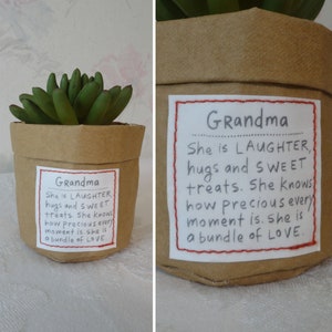 May include: A small, brown paper pot with a green succulent plant. The pot has a white label with the word "Grandma" and a handwritten message about love and laughter.