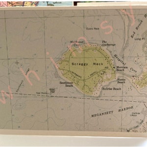 May include: A vintage map of Scraggy Neck, a small island with a green interior and a surrounding body of water. The map shows various features, including beaches, a hospital, and an anchorage. The text "Scraggy Neck" is prominently displayed in the center of the map.