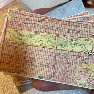 May include: A vintage map of San Francisco, California, showing the Golden Gate Park, Golden Gate Bridge, and surrounding neighborhoods. The map is printed on a cream-colored paper with red and brown lines.