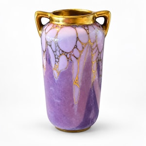 May include: A two-handled ceramic vase featuring a gradient of light lavender to deep purple hues. The upper section is decorated with a network of raised gold lines forming organic, bubble-like shapes, while the rim and handles are finished in gold.