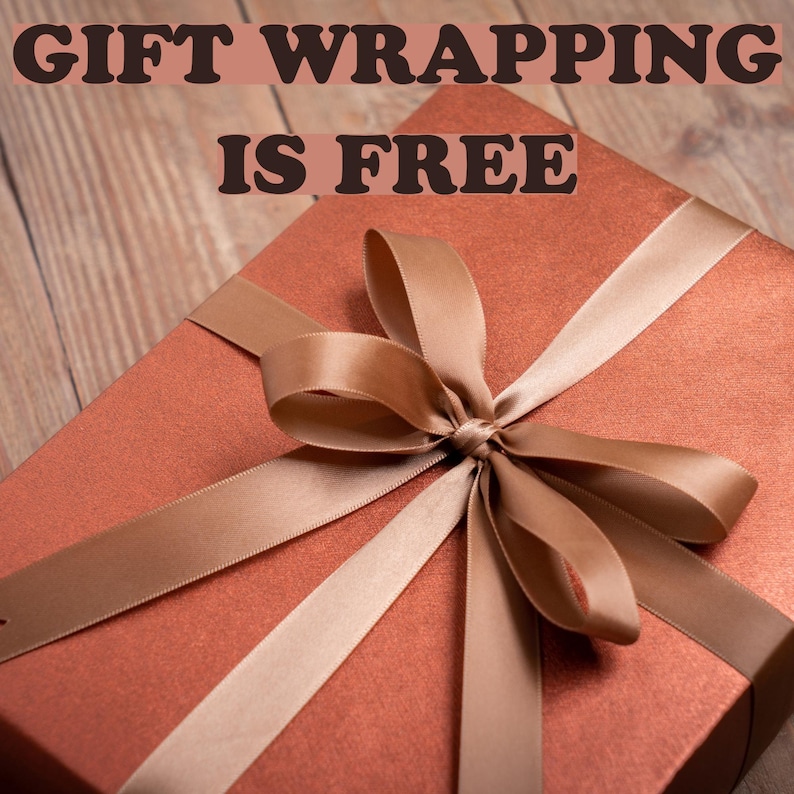 May include: A wrapped gift box in a reddish-brown hue, adorned with a satin ribbon in a complementary shade. The text "GIFT WRAPPING IS FREE" is displayed across the top of the image.