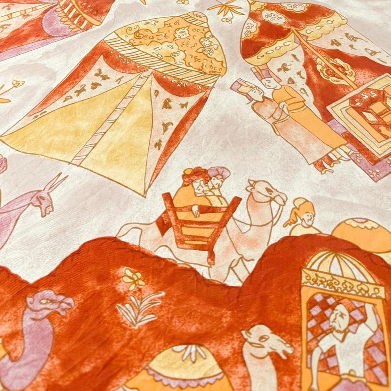 May include: A fabric featuring a printed illustration of desert scenes with camels, figures in traditional attire, and ornate tents. The color palette consists of shades of orange, yellow, and light purple on a pale, off-white background.