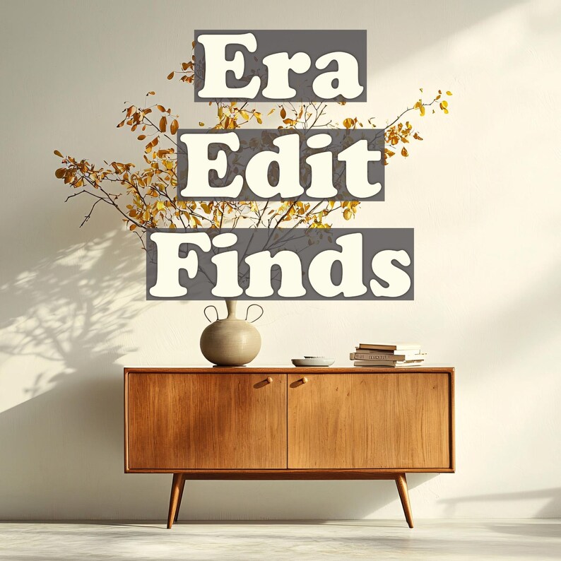 May include: A mid-century modern wooden cabinet with two doors and angled legs. A beige ceramic vase and a small stack of books sit on top. The text "Era Edit Finds" is displayed above the cabinet.
