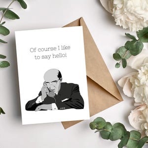 May include: Greeting card with a black and white illustration of a man wearing glasses and a suit, holding a phone to his ear. The card reads "Of course I like to say hello!" with a brown envelope in the background.