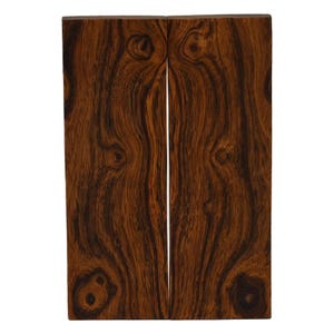 May include: Two rectangular pieces of wood with a rich, dark brown color and intricate grain patterns. The wood has dark brown and black streaks, with knots and swirls adding to its natural beauty. The pieces are side by side, with a small gap between them.