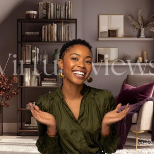 May include: A woman in an olive green blouse smiles in front of a bookshelf and a chair. The background includes a bookshelf filled with books, decorative items, and the text "Virtuviews". A purple throw and pillow are on the chair.