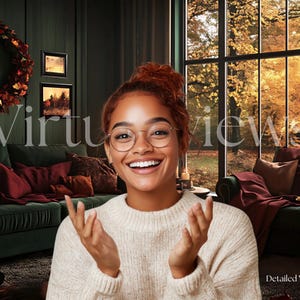 May include: A woman with brown hair and glasses smiles and gestures with her hands in front of a green sofa and a large window with autumn foliage. The sofa has red and brown cushions. The text "Virtual Views" is superimposed on the image.