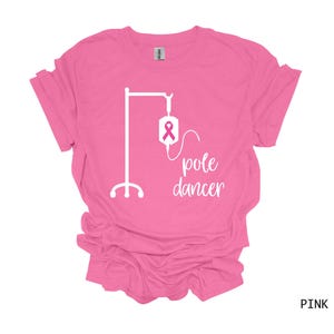 May include: Pink t-shirt with a white graphic of an IV pole and the text "pole dancer".