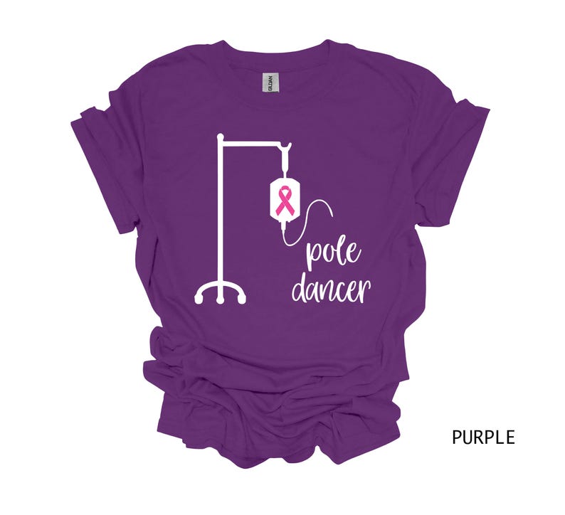 May include: Purple t-shirt with a white graphic of an IV pole with a pink ribbon and the text "pole dancer".