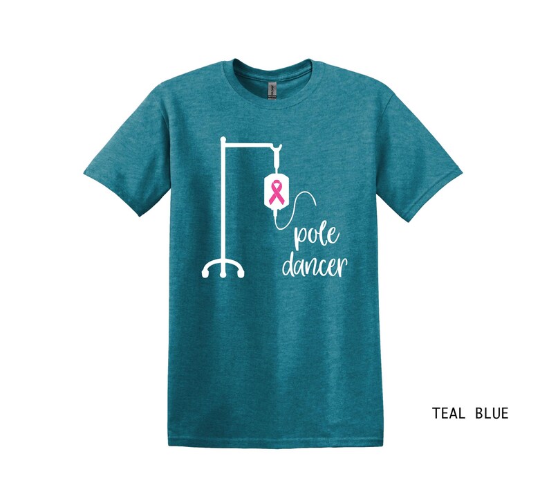 May include: Teal blue t-shirt with a white graphic of an IV pole with a pink ribbon on the bag and the text "pole dancer".