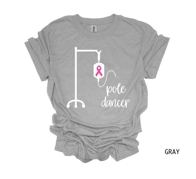 May include: Gray t-shirt with a white graphic of an IV bag with a pink ribbon and the text "pole dancer".