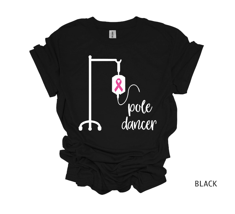 May include: Black t-shirt with a white graphic of an IV pole and the text "pole dancer". A pink ribbon is on the IV bag.