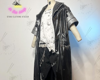 May include: A black leather jacket with a white t-shirt underneath. The jacket has a distressed look with stitching and frayed edges. The t-shirt has a white and gray tie-dye pattern. The model is wearing black pants with a silver chain belt.