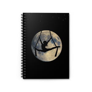 May include: A black and white illustration of a person performing aerial silks against a backdrop of a full moon and a starry night sky.