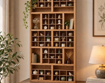 May include: A tall, rectangular wooden display shelf with numerous small, square cubby compartments. The shelves are filled with various miniature decorative items, including small glass bottles, figurines, tiny plants, and books.