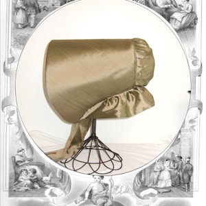 May include: A green silk coal shuttle bonnet with a ruffled trim. The bonnet is displayed on a black metal stand. The image includes the text "Timely Tresses" and "Louisa Ann Pattern and Instructions for Creating a Nineteenth Century Coal Shuttle Bonnet".