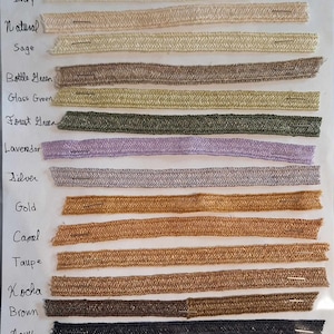 May include: A chart of hemp plait straw millinery braid in various colors, including cream, natural, sage, bottle green, glass green, forest green, lavender, silver, gold, camel, taupe, kocha, brown, navy, and black.