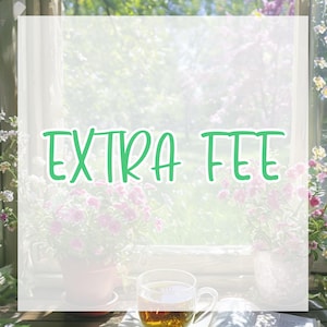 May include: A clear glass mug filled with tea sits on a wooden surface, with the text "EXTRA FEE" in green script. The background features a window with flowers and a soft, blurred view of the outdoors.