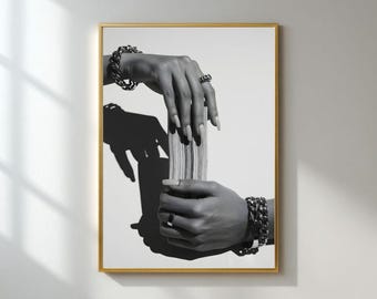 May include: Black and white framed art print featuring hands adorned with rings and chunky bracelets. The hands are holding a stack of cards, casting a shadow. The artwork is displayed in a gold frame.