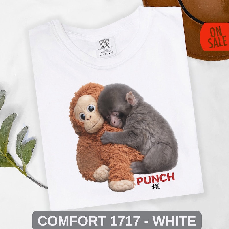 Retro style monkey graphic tee featuring baby macaque hugging plush toy