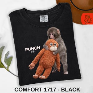 Cute monkey graphic tee with baby macaque holding stuffed monkey