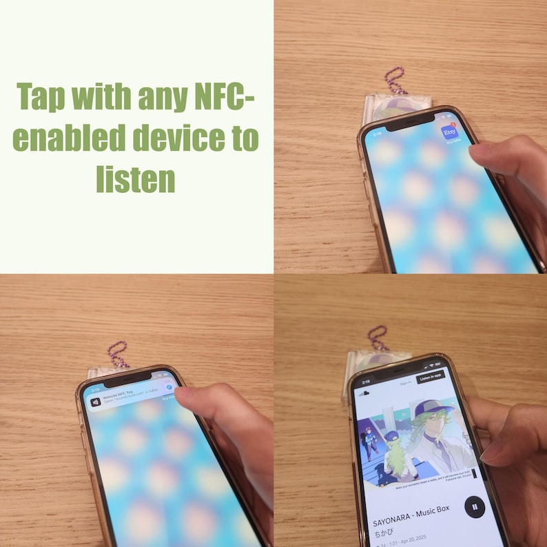 May include: A smartphone showing a music app interface. A finger is tapping the screen. The text "Tap with any NFC-enabled device to listen" is in the upper left. A small charm is attached to the phone. The phone is on a wooden surface.