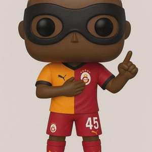 Op de afbeelding: Een Funko Pop-figuur van een voetballer in een rood-geel shirt met nummer 45. De figuur heeft een zwart masker, blond haar en rode voetbalschoenen. De figuur staat in een wijzende pose.