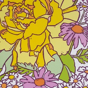 May include: A yellow flower with a pink center, surrounded by smaller white flowers with yellow centers. The flowers are drawn in a cartoon style with thick black outlines.