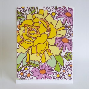 May include: A yellow and white floral illustration with a large yellow flower in the center surrounded by smaller white and purple flowers.