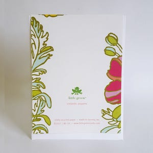 May include: A white card with green and yellow floral designs on the edges. The card has the text "little green&trade; icelandic poppies" in green text. The bottom of the card has the text "100% recycled paper made in tacoma, wa &copy;2017/BK-10 www.littlegreencards.com" in black text.